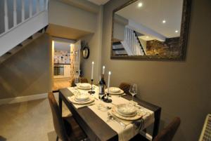 a dining room with a table and a mirror at 54 On the Rocks- characterful coastal cottage in Anstruther