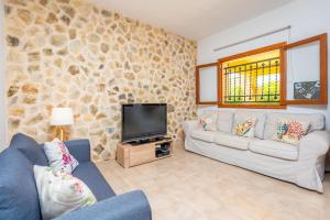 a living room with a couch and a tv at Raco De Can Pep in Inca