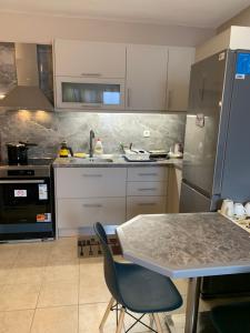 a kitchen with a table and chairs in it at Holidays Pelion studio in Nea Anchialos
