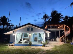a small house with a porch at night at Earnhomestay sichon in Ban Plai Thon