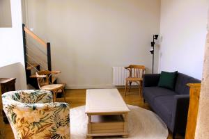 a living room with a couch and chairs at La Bauderie in Bussières