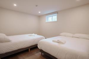 Cama o camas de una habitación en Chalets OST Shefford FORFAIT GROUPE