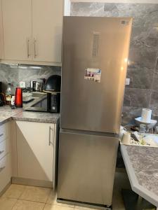 a stainless steel refrigerator in a kitchen at Holidays Pelion studio in Nea Anchialos
