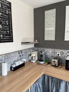 a kitchen with a counter top with a coffee machine at La Colinière Sambin in Sambin +13 photos