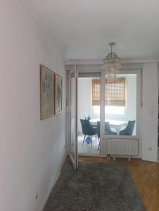 a living room with a table and a chandelier at CityComfort Tuzla in Tuzla
