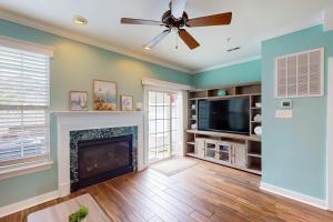 a living room with a fireplace and a ceiling fan at The Villages of Five Points --- 17228 Chatham St in Lewes