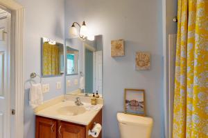 a bathroom with a sink and a toilet and a mirror at The Villages of Five Points --- 17228 Chatham St in Lewes +16 photos
