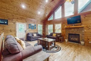 a living room with a couch and a fireplace at The Honey Bee in Pigeon Forge