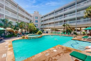 a large swimming pool in front of a building at Casa Del Mar - Mi Casa 113 in Galveston