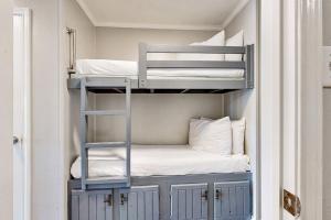 a bunk room with two bunk beds and a ladder at Casa Del Mar - Mi Casa 113 in Galveston +21 photos