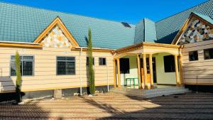a large white building with a gambrel roof at R Kelly Tanzania in Arusha