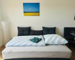 a bed with a green shirt sitting on top of it at Ferienwohnung Albert in Bannesdorf