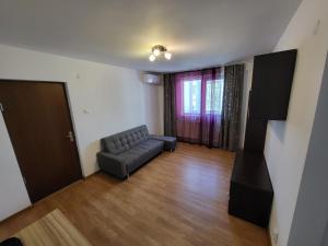 a living room with a couch and a window at Studio Veteranilor in Bucharest