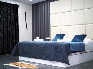 a bedroom with a bed with blue and white sheets at Mediterranean Moon House in Alicante +70 photos