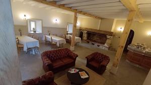 a living room with couches and a table and a fireplace at Abbaye Saint Gilbert in Les Baux