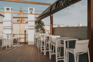 a row of tables and chairs on a balcony at Vincci Selección Posada del Patio in Málaga