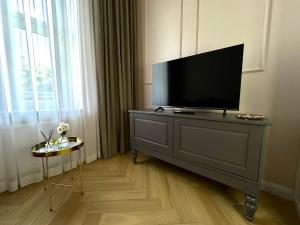 a flat screen tv on a dresser in a room at Suites & Premium Apartments Słowackiego in Kielce