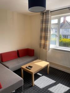 a living room with a couch and a coffee table at Aylstone Gem in Leicester +1 photo