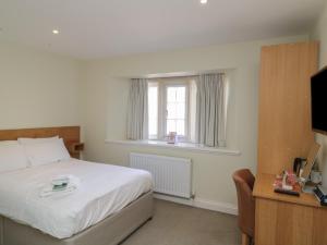 a bedroom with a bed and a window at Harcombe House Rooms - First Floor Double in Newton Abbot