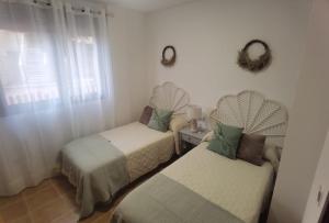 a room with two twin beds and a window at Laurent's house - ATTC International Vacations in Isla del Fraile