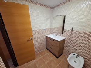 a bathroom with a sink and a toilet and a door at Laurent's house - ATTC International Vacations in Isla del Fraile +3 photos