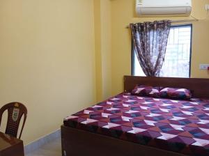 Postel nebo postele na pokoji v ubytování Rukmini Guest House