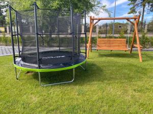 a swing set in a yard with a bench at Sorella House in Sianozety