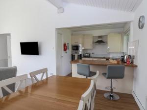 a kitchen and dining room with a table and chairs at Harcombe House Accessible Pet Free Bungalow Sleeps 6 in Newton Abbot