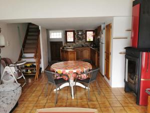 a kitchen with a table in the middle of a room at Bord de Lac in Saint-Julien-du-Verdon