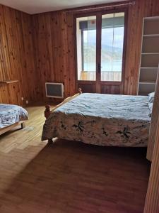 a bedroom with two beds and a window at Bord de Lac in Saint-Julien-du-Verdon