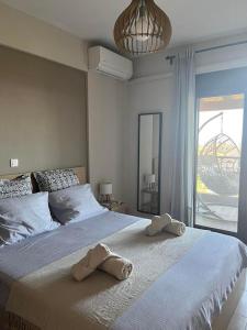 a bedroom with a large bed with towels on it at Stone House in Afytos in Afitos