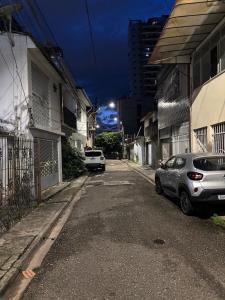 a street with two cars parked on the road at Apartamento capital in Belém +48 photos