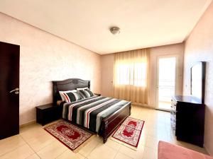 a bedroom with a bed and a window at Family Home -2 in Agadir +25 photos