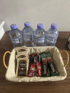a basket filled with water bottles and toothpaste at RINI Apartment in Muruntau
