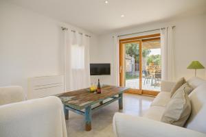a living room with a couch and a table at Can Cadernera by Rentallorca in Can Picafort