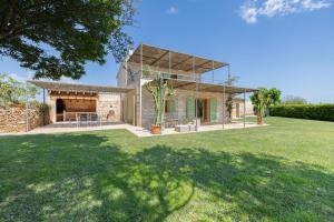 a home with a large yard with a house at Can Cadernera by Rentallorca in Can Picafort