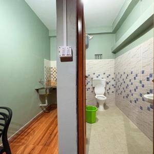 a bathroom with a toilet and a sink at Sangita Homestay in Siliguri