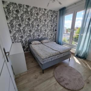 Postel nebo postele na pokoji v ubytování Apartament Skarbowa Sol