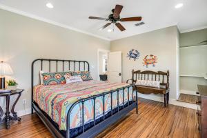a bedroom with a bed and a ceiling fan at The James Pearl in Rockport