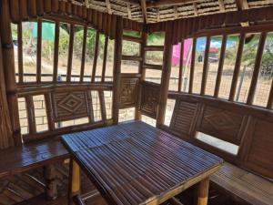 a wooden bench sitting in the middle of a room at Villa Sherbel 88 with Access to White Beach in Calatagan