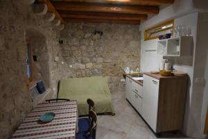 a kitchen with a table and a small kitchen with a counter at Lorenzo Old Town in Dubrovnik