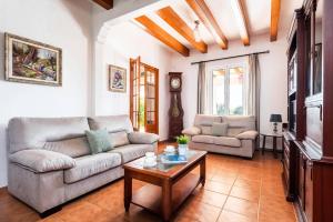 a living room with a couch and a coffee table at Villa Son Esbert by Villa Plus in Alaior