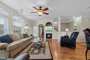 a living room with a couch and a ceiling fan at Legacy Villa 704 in Gulfport