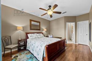 a bedroom with a bed and a ceiling fan at Legacy Villa 704 in Gulfport