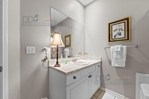 a bathroom with a sink and a mirror at Legacy Villa 704 in Gulfport +11 photos