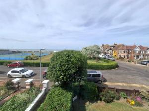 a street with cars parked in a parking lot at Westbrook Lodge Guest House in Margate