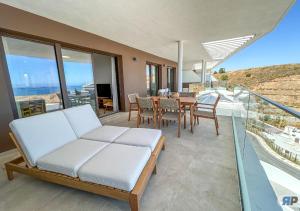 a living room with a couch and a table at Apartamento Senses con vistas al mar y terraza in Rincón de la Victoria +100 photos