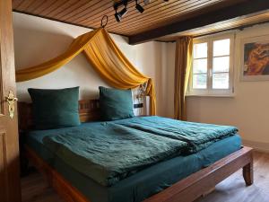 a bedroom with a bed with a blue comforter at Fuchsbau in Lieser