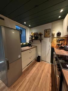 a kitchen with a stainless steel refrigerator and wooden floors at Fuchsbau in Lieser +14 photos