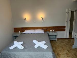 a bedroom with a bed with two crosses on it at Villa Konstantina in Tolo